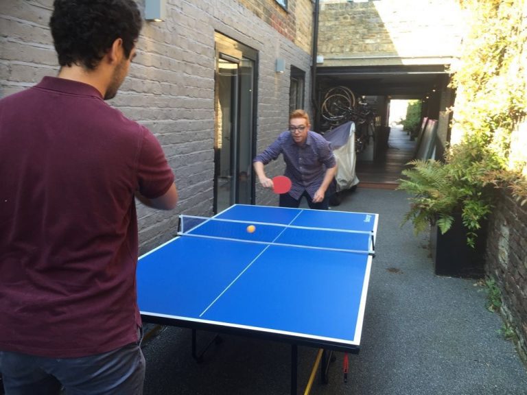 Colleagues playing Ping Pong at Givergy 